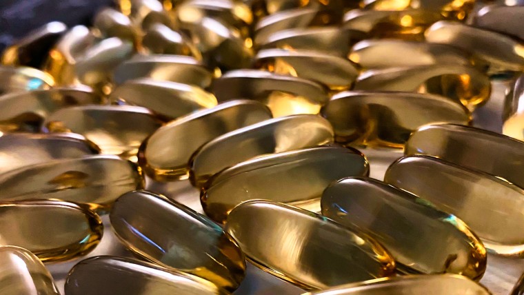 Golden capsules on a flat surface.